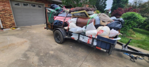 An overloaded trailer filled with household junk and debris, ready for removal by JUNK BRO'S in Hickory, NC.