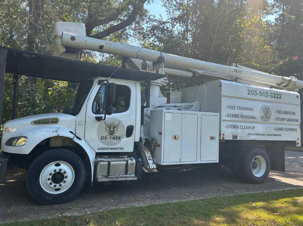 An Ox Tree service truck displaying company logo and a list of services offered in Birmingham, AL.