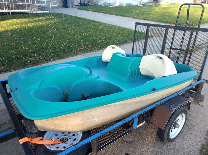 A paddle boat loaded onto a trailer for removal by TrashnSell in Grand Island, NE