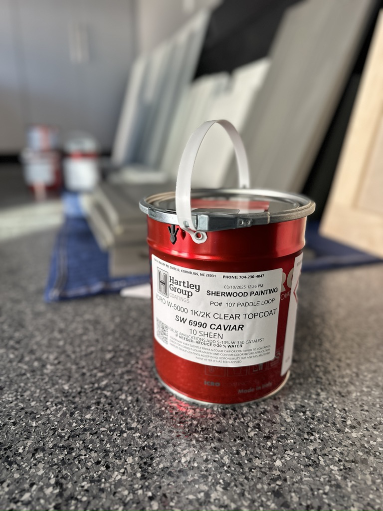 A paint can with the Sherwood Painting Services label, used for cabinet refinishing in Mooresville, NC.