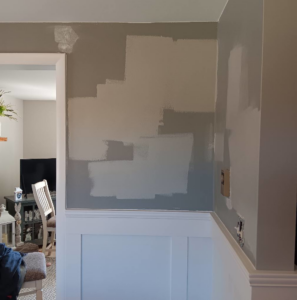 Various paint colors being tested on a wall above white wainscoting by Carter's painting in Martinsburg, WV.