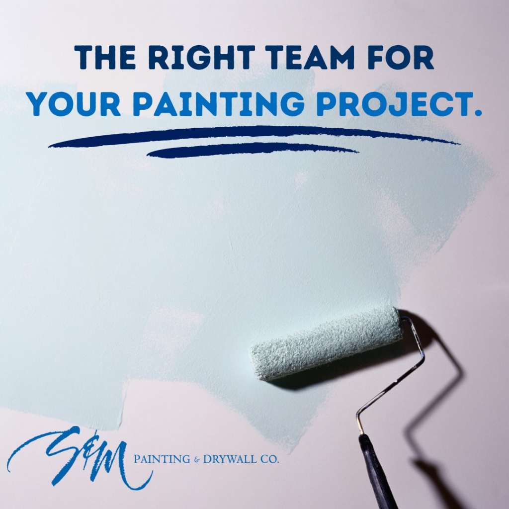A paint roller applying light blue paint to a wall, showcasing services by S&M Painting and Drywall in Carmel, IN.