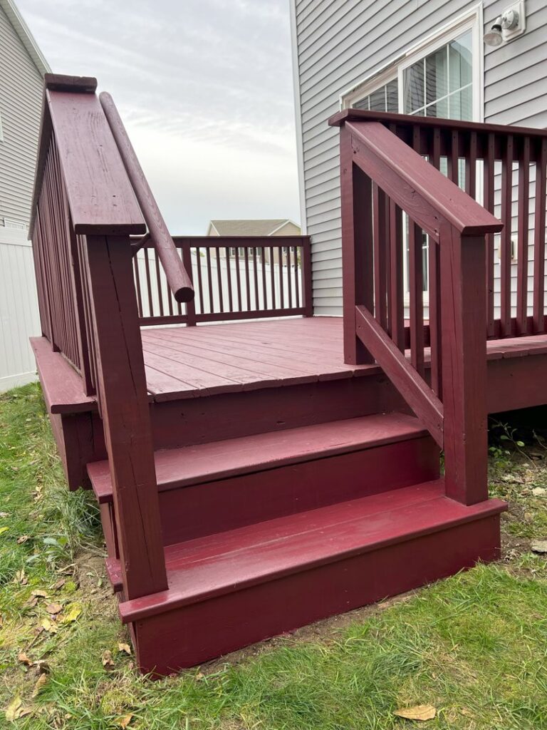 A beautifully finished and painted dark red wooden deck by TD Estimating Group LLC in Springfield, MA, ready for use.