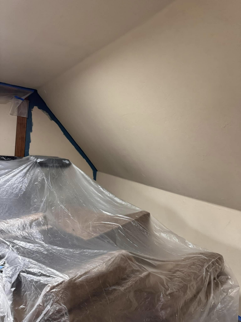 Furniture covered with plastic sheeting for painting preparation, a service by Sanders Construction & Handyman Services, LLC in Oklahoma City, OK.