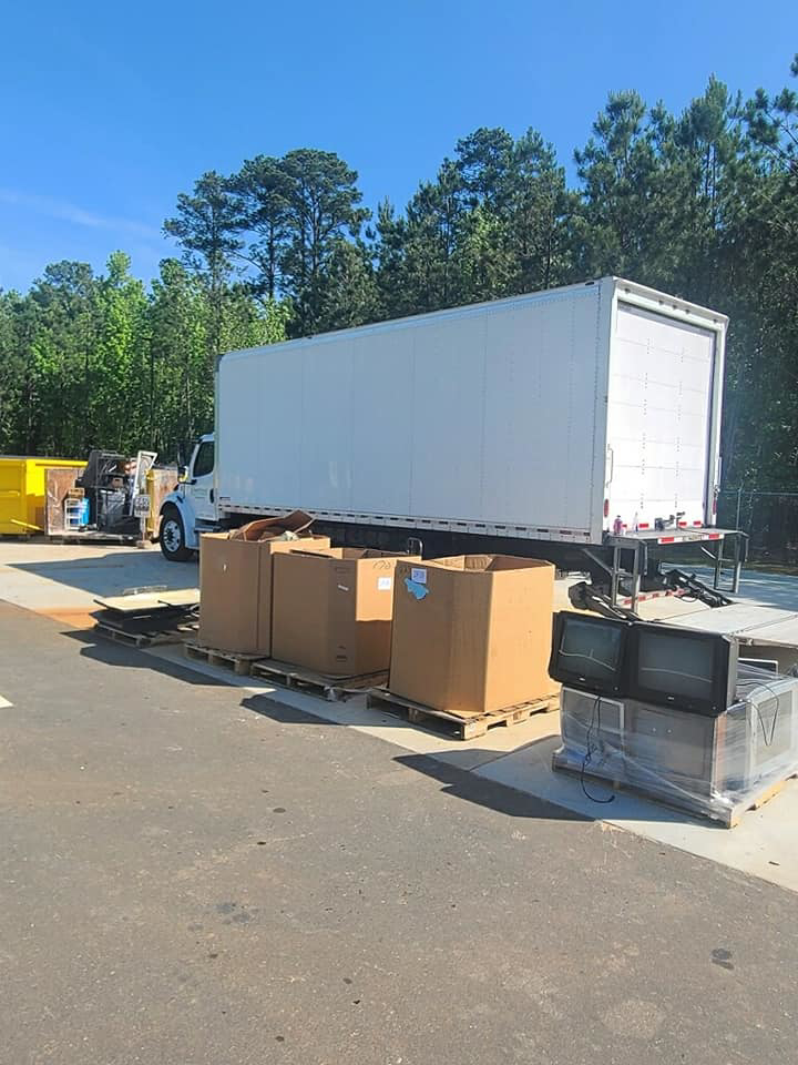 Pallets of old electronics and boxes ready for recycling at Durham County Recycles in Durham, NC