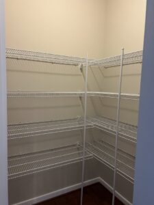 A pantry with newly installed wire shelving and freshly painted walls by Global Painting RVA in Richmond, VA.