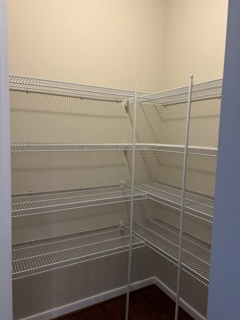 A pantry with newly installed wire shelving and freshly painted walls by Global Painting RVA in Richmond, VA.