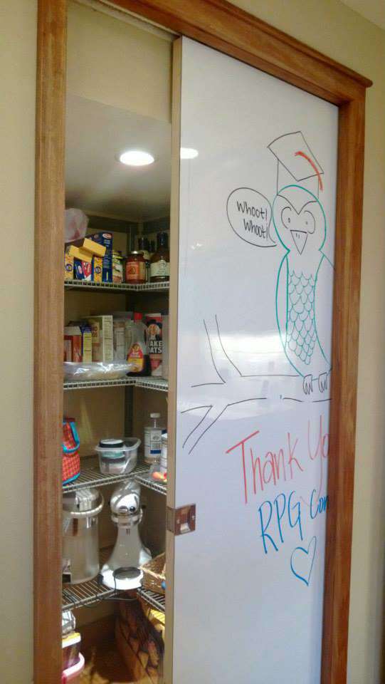 Handyman installing a custom pantry sliding whiteboard door with wooden frame at a home by RPG Construction in Virginia Beach, VA.