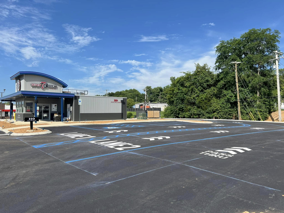 Freshly painted lane and pass-thru markings in a commercial parking lot by Marine One Striping in Clarksville, TN.