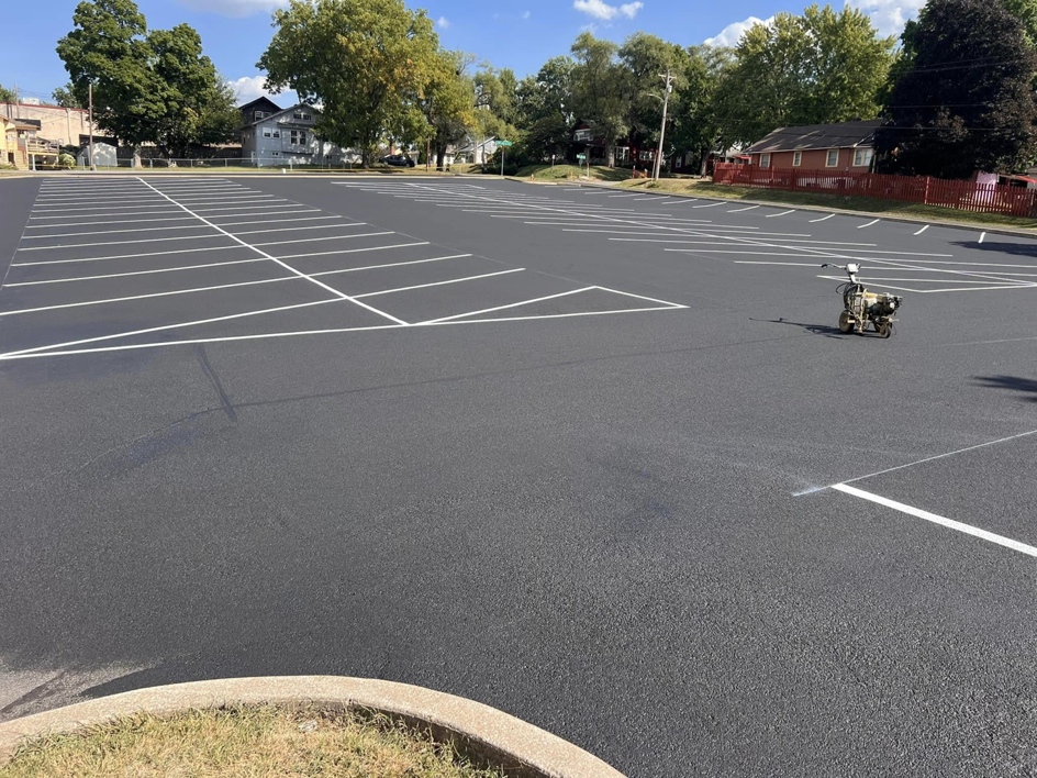 A large asphalt parking lot with new sealcoating and fresh line striping by Gorman sealcoating & striping in Blue Springs, MO.