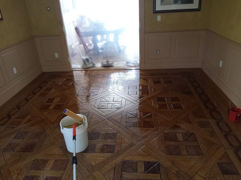 Intricate parquet wood flooring receiving a fresh coat of finish by Robert C. Mihaich Wood Flooring in Worcester, MA.
