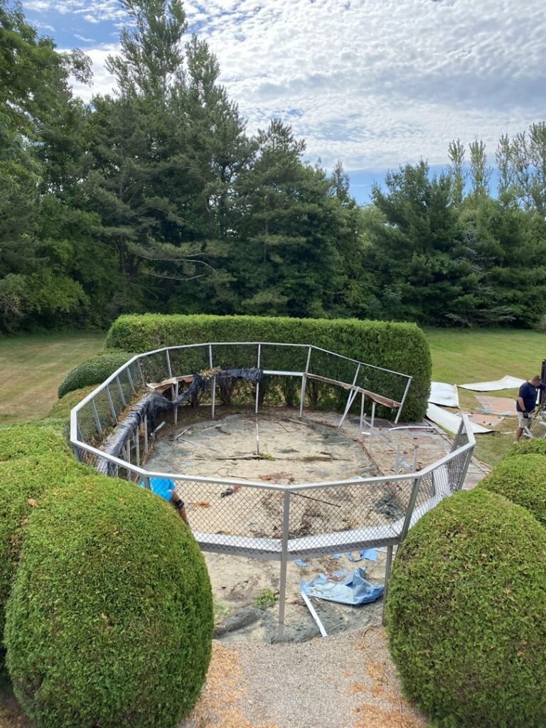 A partially dismantled above-ground pool being removed by CK Junk Removal in New Bedford, MA
