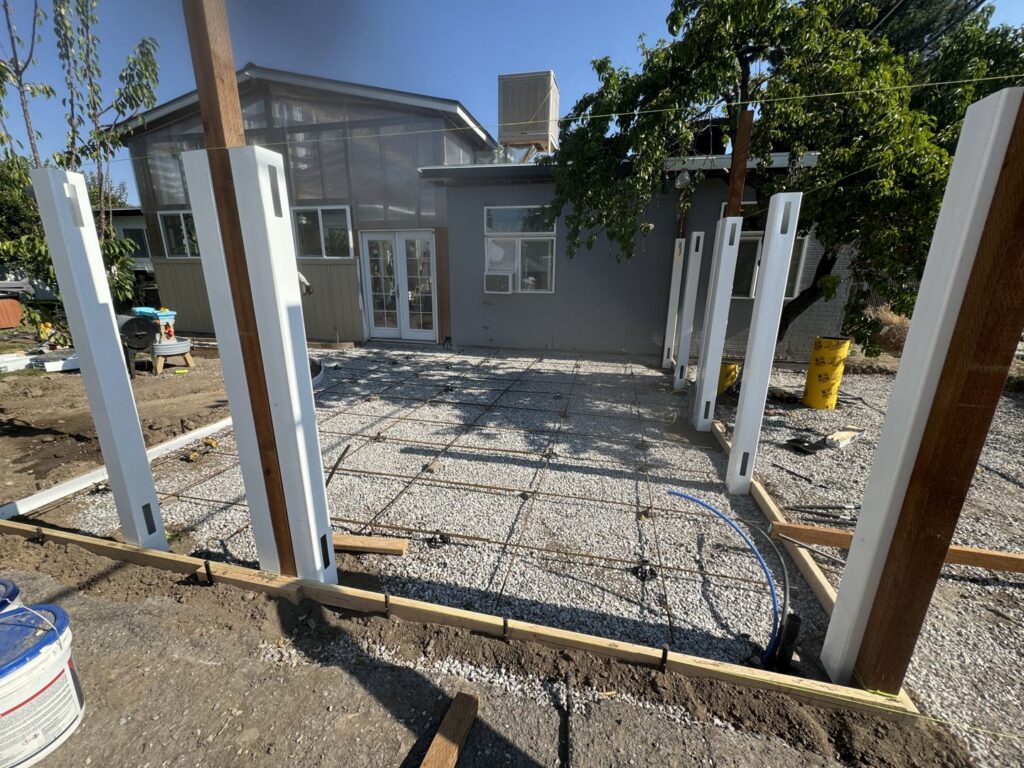 Outdoor patio concrete preparation with rebar and posts by Handyman house repairs and remodeling in Provo, UT