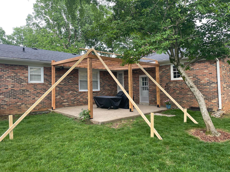 Wooden patio cover construction in progress with temporary supports by HC Homes & Consulting in Bowling Green, KY.