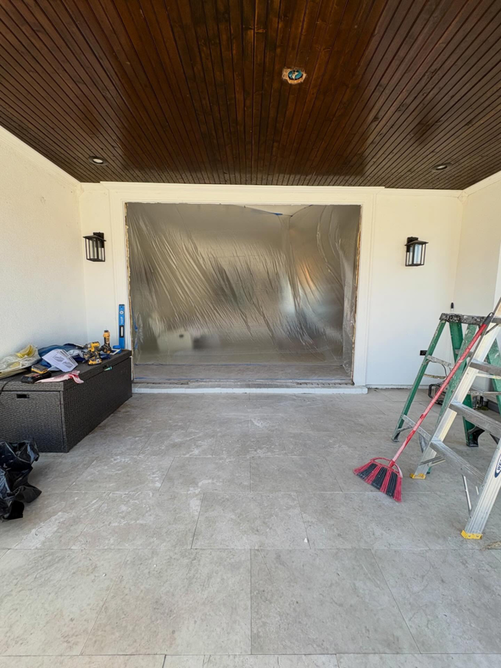 Patio door opening covered with plastic sheeting during a home renovation by JPS Home Builders LLC in Kenner, LA.