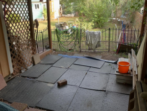 A newly installed outdoor patio floor with black rubber mats by Unified Roofing and Exteriors in Gulf Shores, AL.