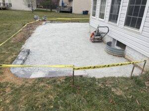 An outdoor patio installation in progress, showing the gravel base and initial paver layout, by Landscape By Today in Bowie, MD.