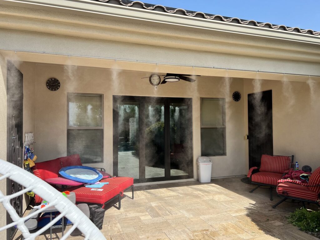 A high-quality mist system installed on a patio with red outdoor furniture by Mr. Mister in Surprise, AZ