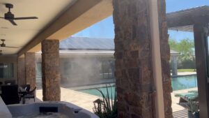 A high-quality mist system installed on a patio with stone pillars and a hot tub by Mr. Mister in Surprise, AZ
