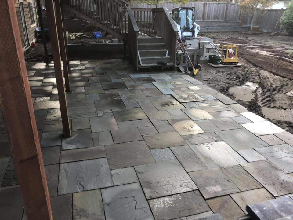 A new backyard patio being installed with pavers by M.C.Dirtworks, a handyman service in Caldwell, ID.