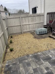 A newly installed paver patio and landscaped area with mulch by Juan M Construction LLC in Waterbury, CT.