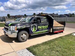 A Patriot Tree Service dump truck filled with wood chips, ready for hauling in Sioux Falls, SD