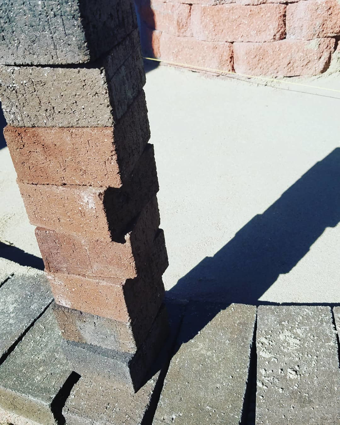A stack of pavers and laid bricks for a patio or walkway installation by Steveson Enterprises, Inc. in Golden, CO.