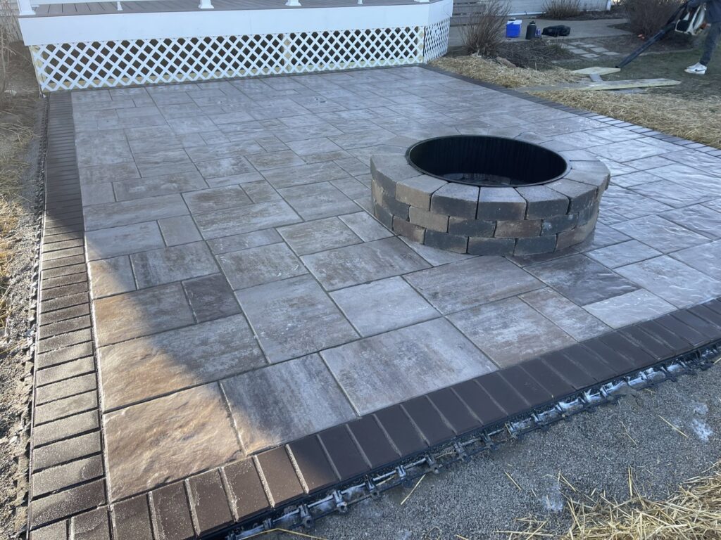 A beautifully completed paver patio with a built-in fire pit, perfect for outdoor living, by Inspired Renovation & Hardscape's in Lorain, OH.