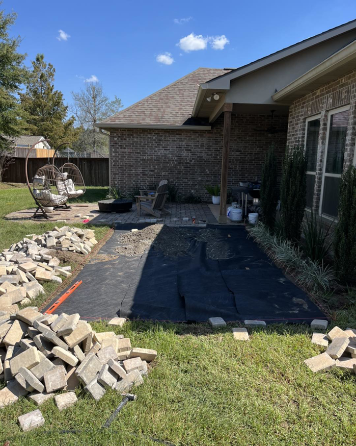 A new paver patio installation in progress with stacks of pavers ready for use by Pedro Pavers LLC in New Orleans, LA