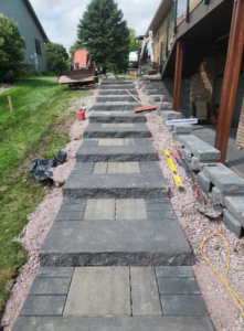 Outdoor paver staircase and walkway under construction by Great Plains Remodeling and Handyman Services in Mitchell, SD.