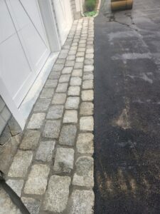 Paver stone border installed next to a garage door by Leo Brothers Contracting in Danbury, CT.