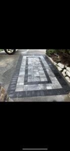 A newly installed paver walkway with a decorative pattern by Mincho Contractor LLC in Jersey City, NJ