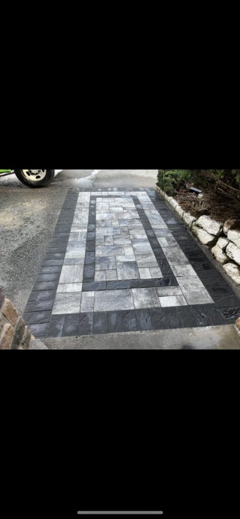 A newly installed paver walkway with a decorative pattern by Mincho Contractor LLC in Jersey City, NJ