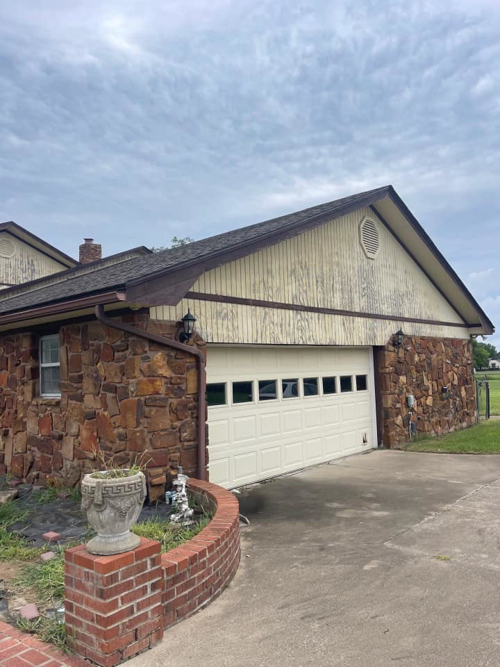 Peeling siding above a garage door, showing a common exterior maintenance need for Construction Doctor in Littleton, CO.