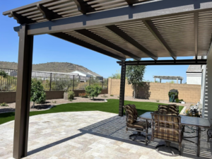 A completed brown pergola and patio offering a beautiful desert view by Az Sun Covers in Glendale, AZ.