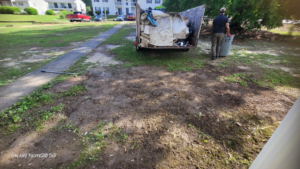 A person loading junk and debris into a trailer for removal by Ashworth Clean Up Crew LLC in West Columbia, SC.