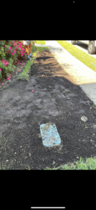 A person raking soil for a landscaping project, demonstrating handyman services by A and T Services LLC in North Charleston, SC.
