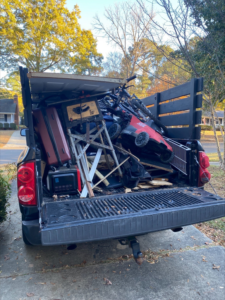 A pickup truck bed overflowing with various items and junk, ready for removal by Restoration Hauling Co. in Rock Hill, SC.