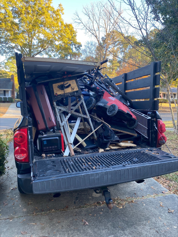 A pickup truck bed overflowing with various items and junk, ready for removal by Restoration Hauling Co. in Rock Hill, SC.