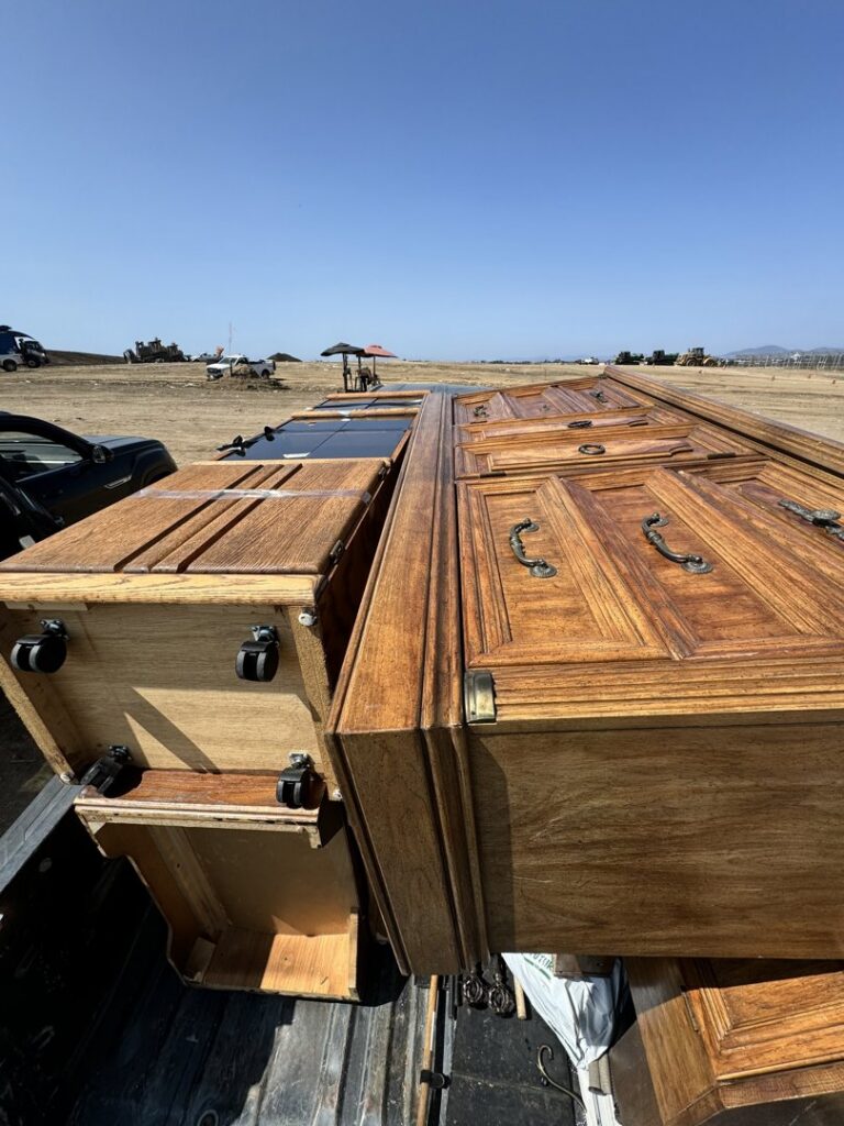 A pickup truck loaded with wooden furniture and cabinets for removal by Johan's Junk Removal and Hauling in San Diego, CA