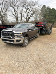 A pickup truck towing a dump trailer, ready for junk removal services by C&C Dumpster Rentals LLC in Conway, AR.