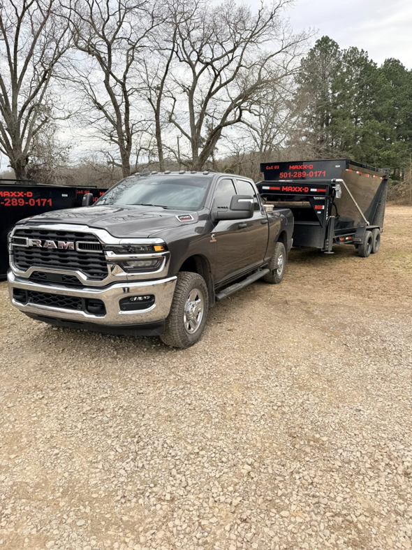 A pickup truck towing a dump trailer, ready for junk removal services by C&C Dumpster Rentals LLC in Conway, AR.