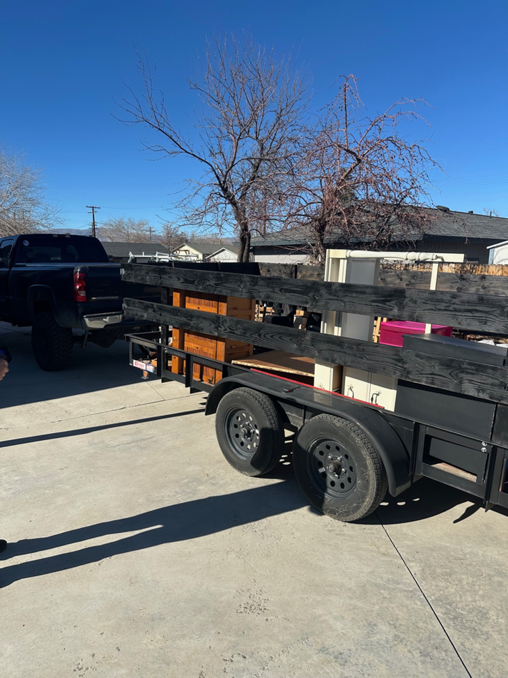 A Fernley Fast Haul pickup truck towing a utility trailer loaded with items for junk removal in Fernley, NV
