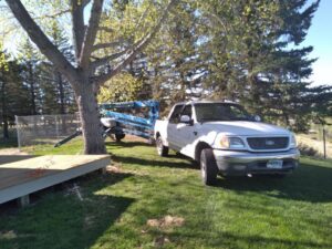 A pickup truck with a tree service trailer, ready for work by All American Arborists in Rock Springs, WY.