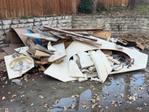 A large pile of construction debris, including broken sinks and wood, ready for junk removal by Grawe Junk & Demo in Arlington, TX.