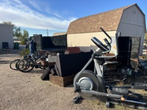 A large pile of various junk items including an elliptical, bikes, and furniture, ready for removal by Southwestern Dumpster Rental and Junk Removal in Peoria, AZ.