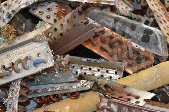 A pile of old AC coils and condensers collected for scrap metal recycling by Bee Green Recycling in Richmond, VA