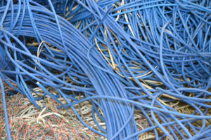 A large pile of blue electrical wires collected for recycling by Bee Green Recycling in Richmond, VA
