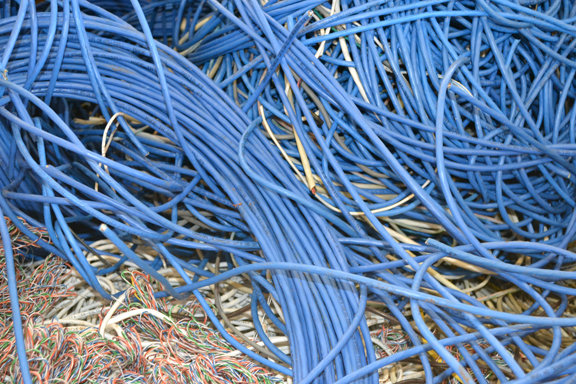 A large pile of blue electrical wires collected for recycling by Bee Green Recycling in Richmond, VA