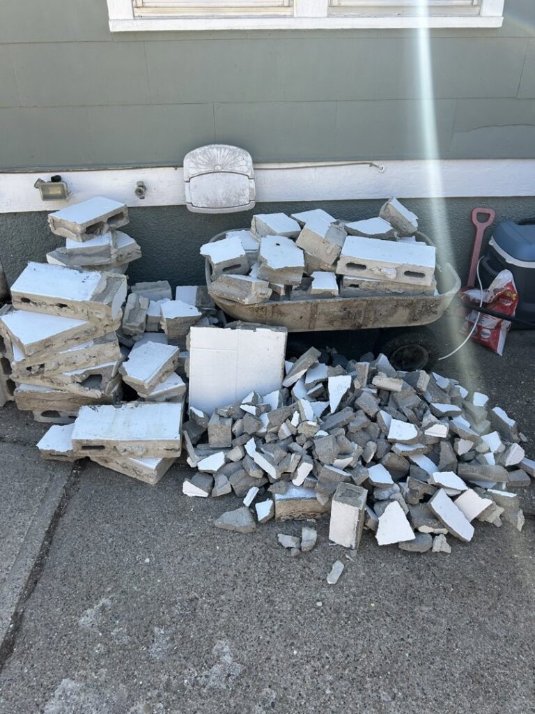 A large pile of broken concrete and construction debris ready for removal by The Goat Junk Removal in Ankeny, IA